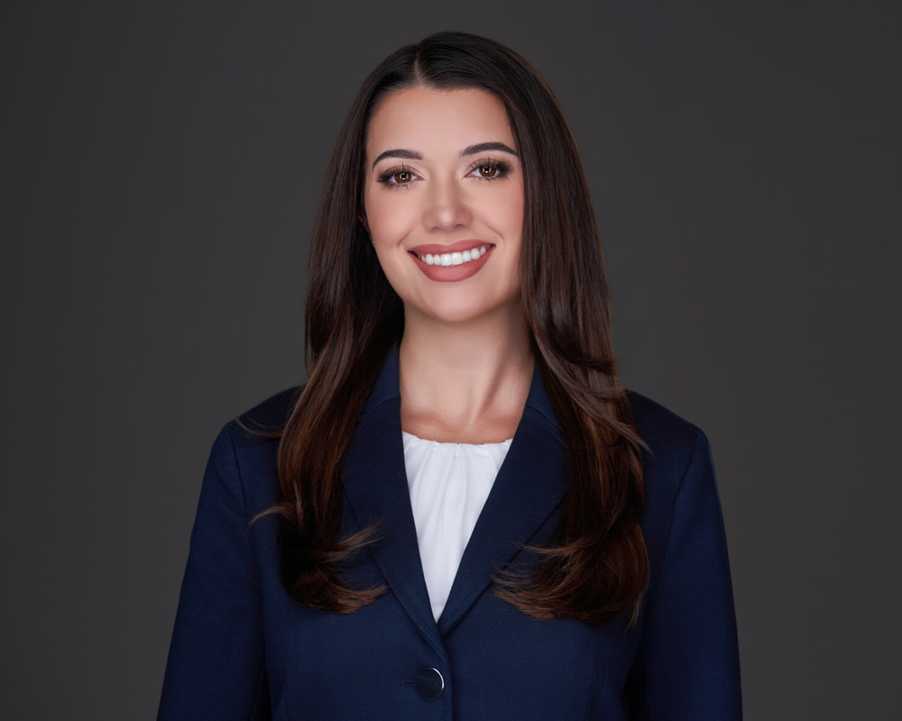 Professional headshot of Grace Perez de la Mesa a young brunette associate attorney
